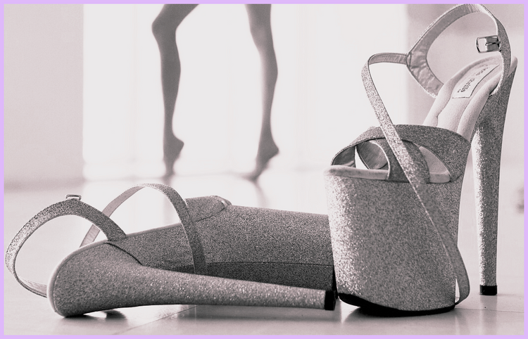 Pair of glitter platform heels for pole dance with dancer silhouette in background studio