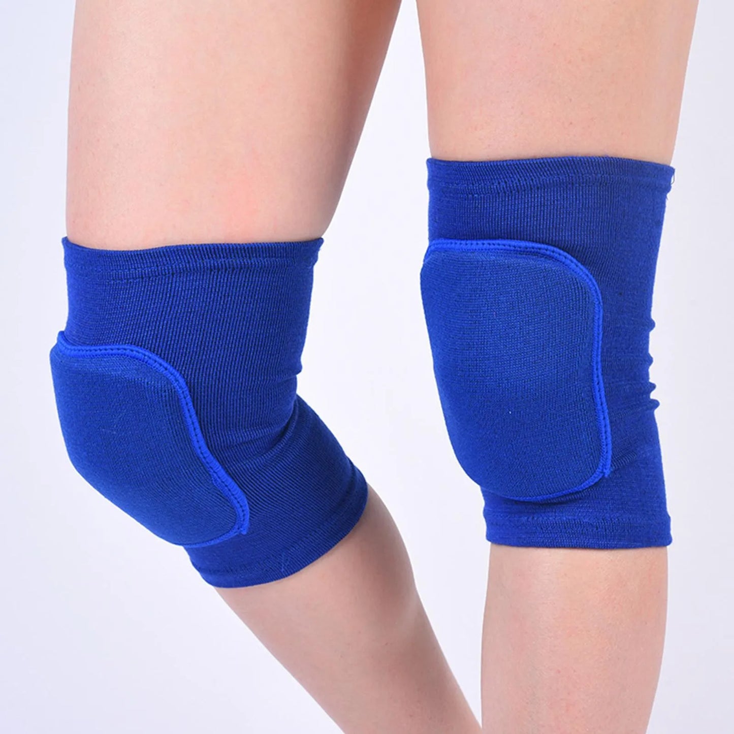 Blue closed knee pads with padded protection over knees, worn on legs, elastic fabric.
