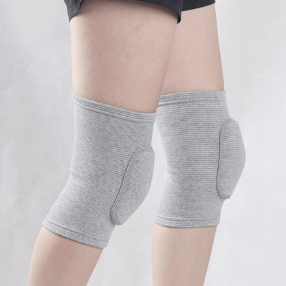 Grey closed knee pads with padded protection over knees, worn on legs, elastic fabric.