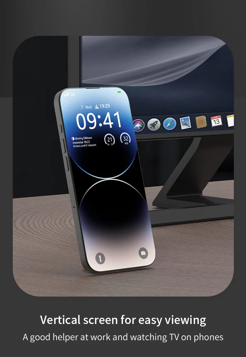 Magnetic ring holder supporting a smartphone in vertical position on a desk, positioned in front of a computer monitor.
