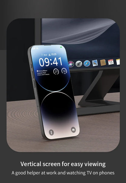 Magnetic ring holder supporting a smartphone in vertical position on a desk, positioned in front of a computer monitor.