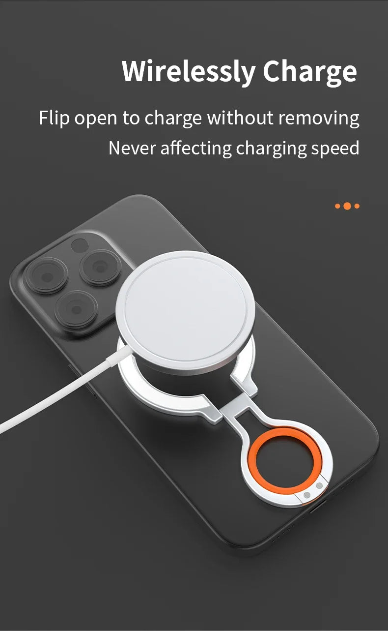 Smartphone with a magnetic ring holder flipped open to allow wireless charging with a MagSafe charger, demonstrating that the device charges without removing the ring holder.