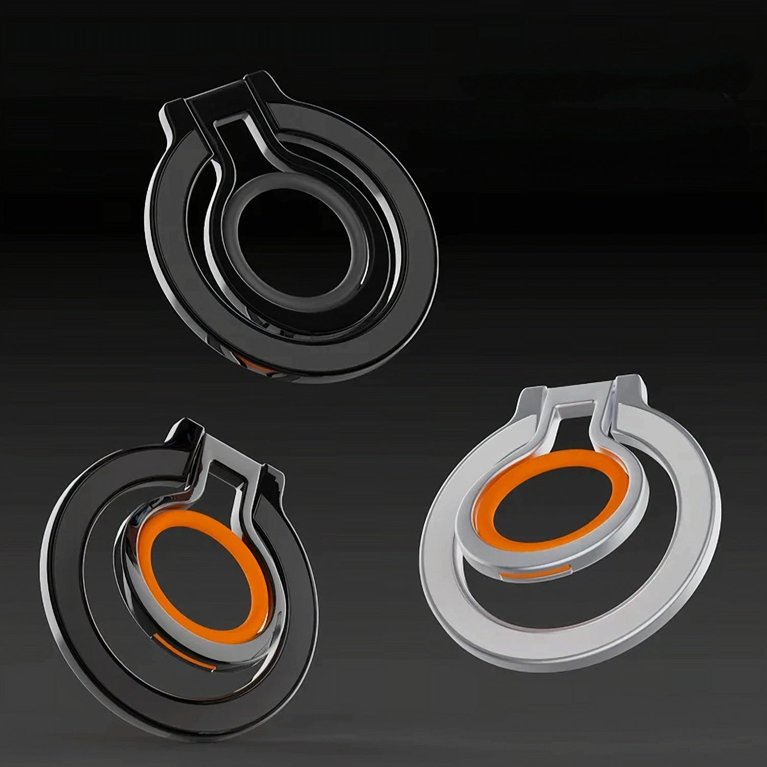 Three magnetic ring holders in black and silver color variants arranged in a dynamic composition against a black background.