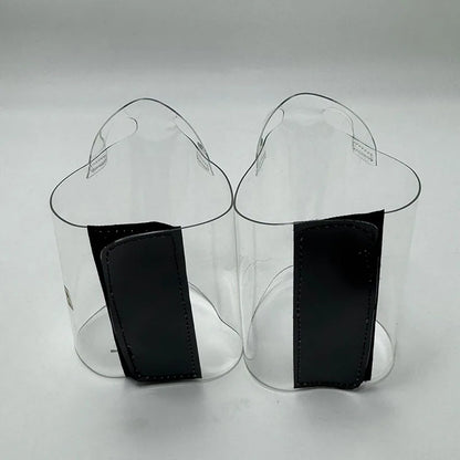 Pair of Transparent platform protectors with a black rear hook-and-loop closure heel shown from the back