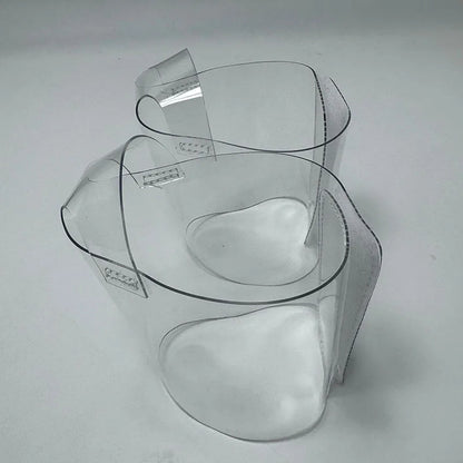 Pair of Transparent platform protectors with a white rear hook-and-loop closure heel shown from the side