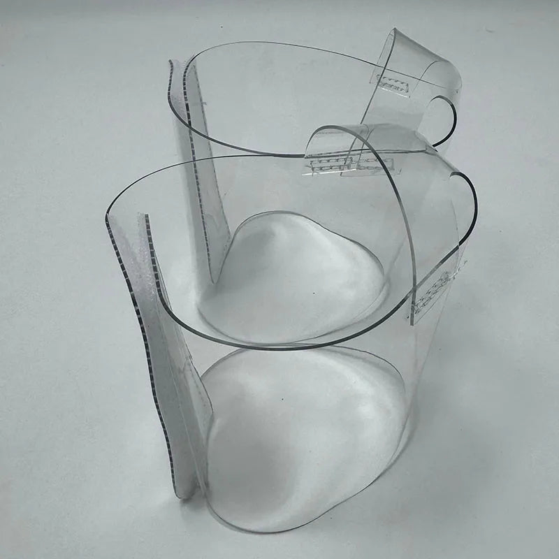 Pair of Transparent platform protectors with a white rear hook-and-loop closure heel shown from the side