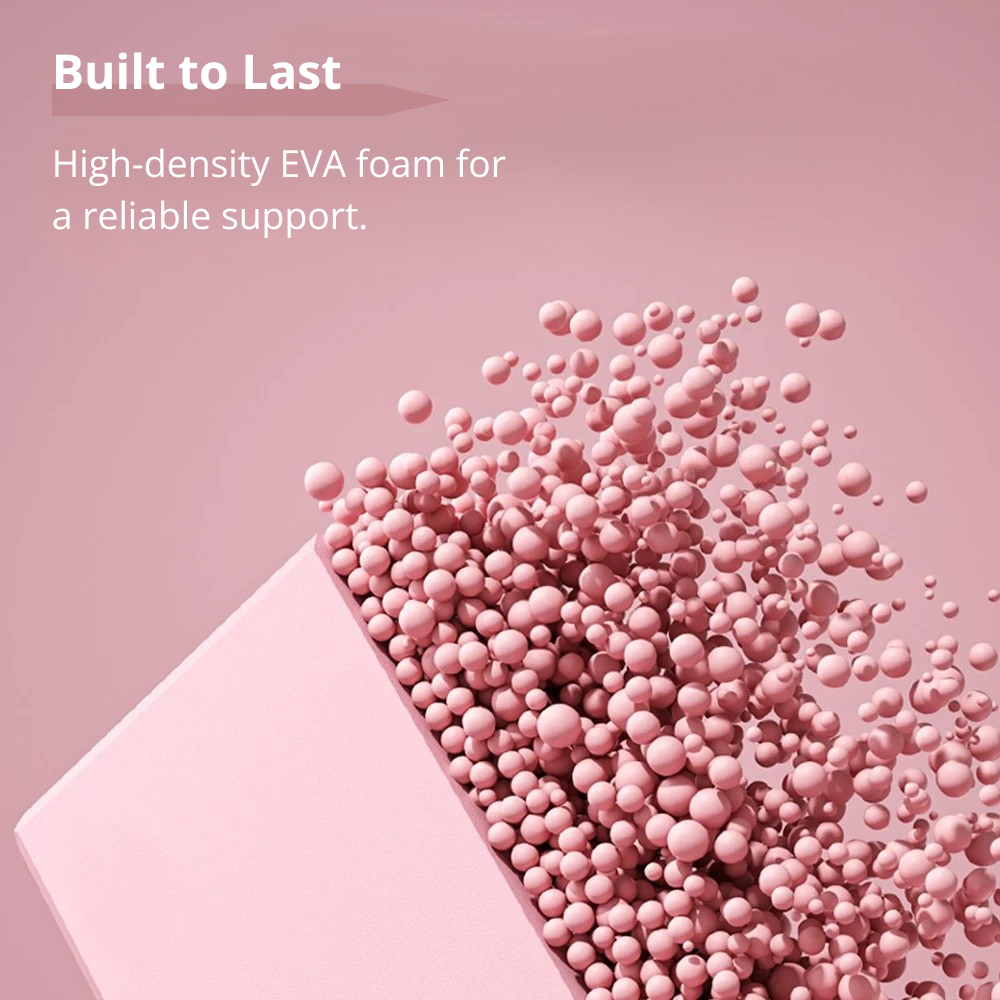 Artistic image of a pink yoga block with a cutout, from which numerous small pink spheres are spilling out. Text reads 'Built to Last. High-density EVA foam for a reliable support.